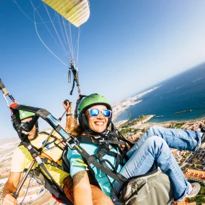 vacancesguadeloupe__cheerful-happy-woman-to-paraglyde-experience-with-2026-01-08-07-30-55-utc